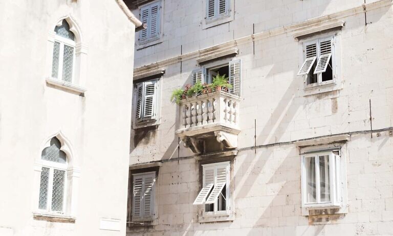 green potted plant on brown concrete house balcony